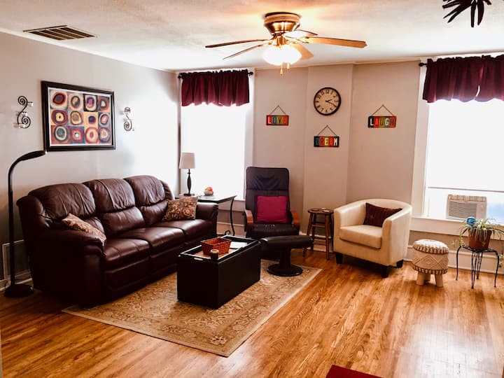 Spacious living room open to kitchen with refinished hardwood floors & lots of natural light.  