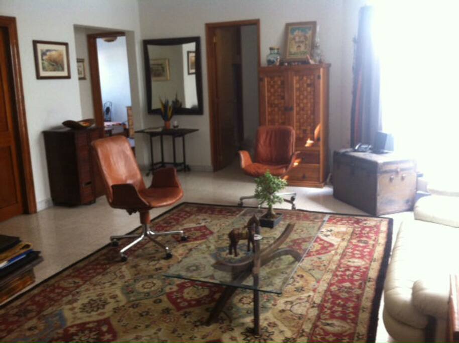 Living room upon entering the apartment, bright light is day light from the Terrace