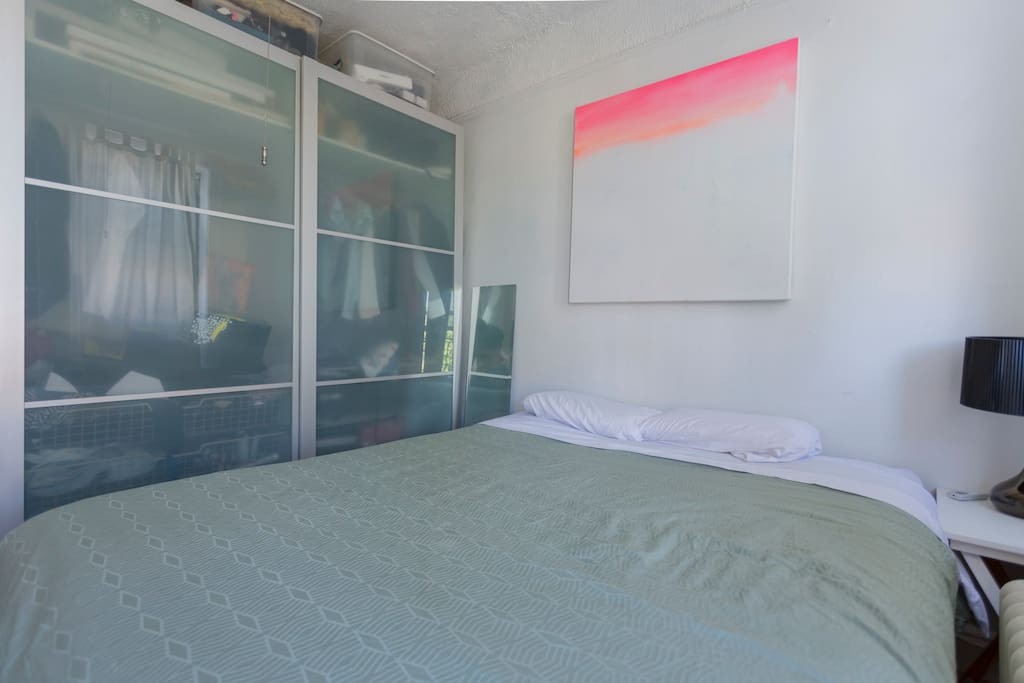Bedroom with a cabinets, closet space and queen size bed