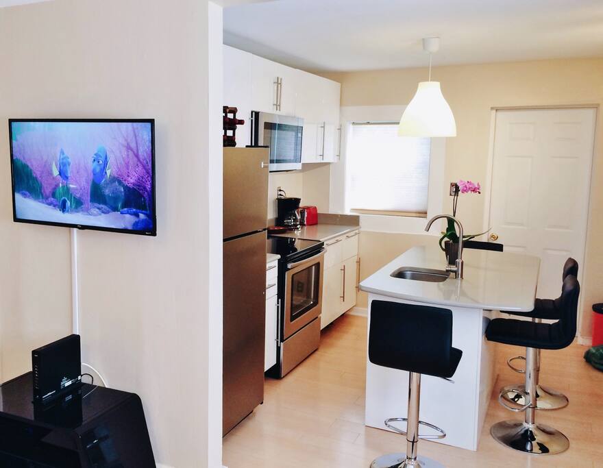 Living room with Smart TV and Kitchen