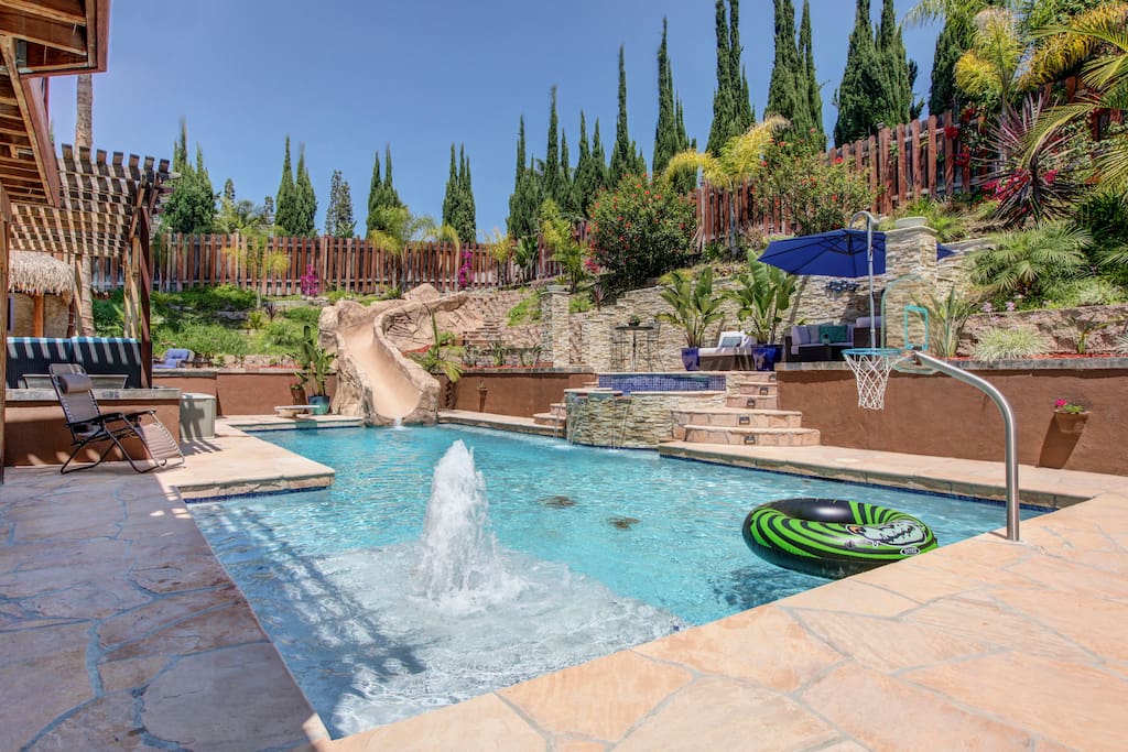 Huge pool and spa with several water features including slide and diving board!!
