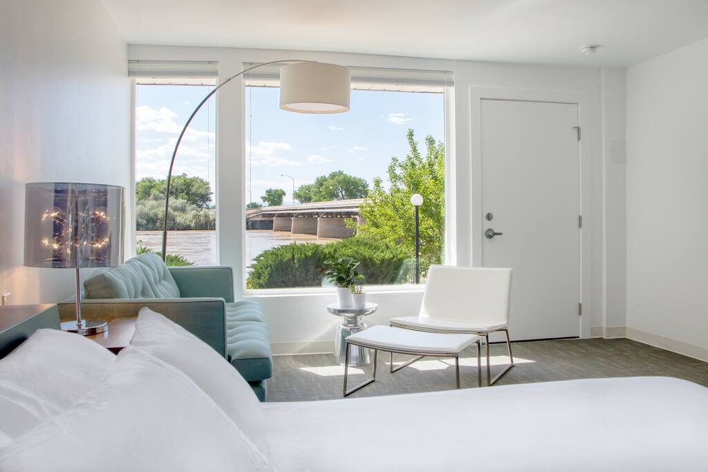 Comfy queen bed and seating area in the Book Cliffs Guestroom
