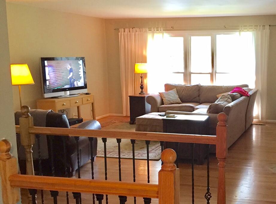 Den with flat screen TV, fireplace and view of the lake
