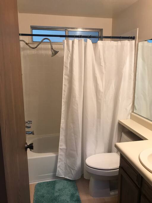 Private bathroom with available hair dryer, towels, and some essentials.