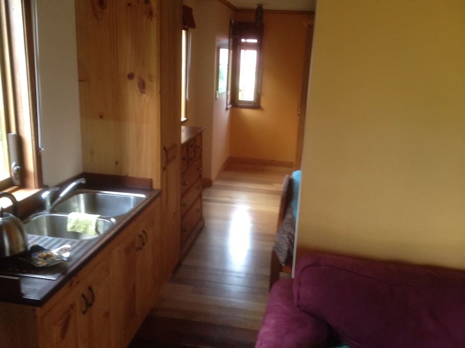from the entry past kitchenette, bedroom beyond