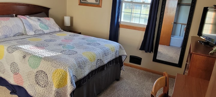 Guestroom #1.  Queen bed with adjustable  base. 32" TV and a desk.  Full closet with hangers, a dresser and a luggage rack.