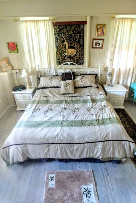Comfortable King size bed under ceiling fan.