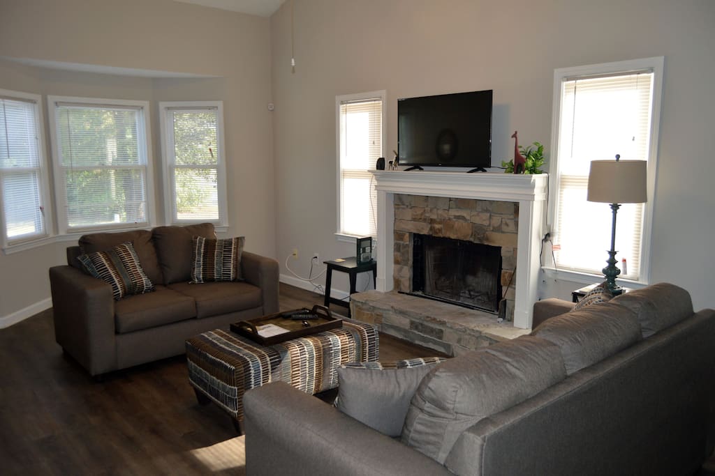 Comfortable living room with flat screen TV over fireplace.