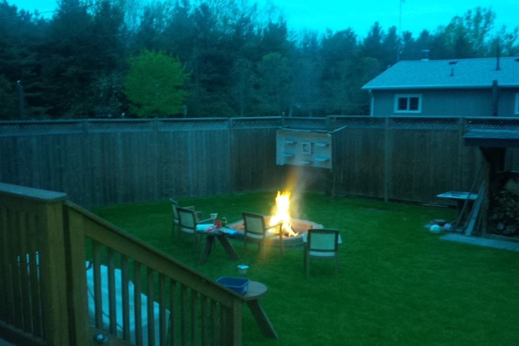 Plenty of back yard space in this fully fenced in yard with large fire pit and barbecue for family entertaining.