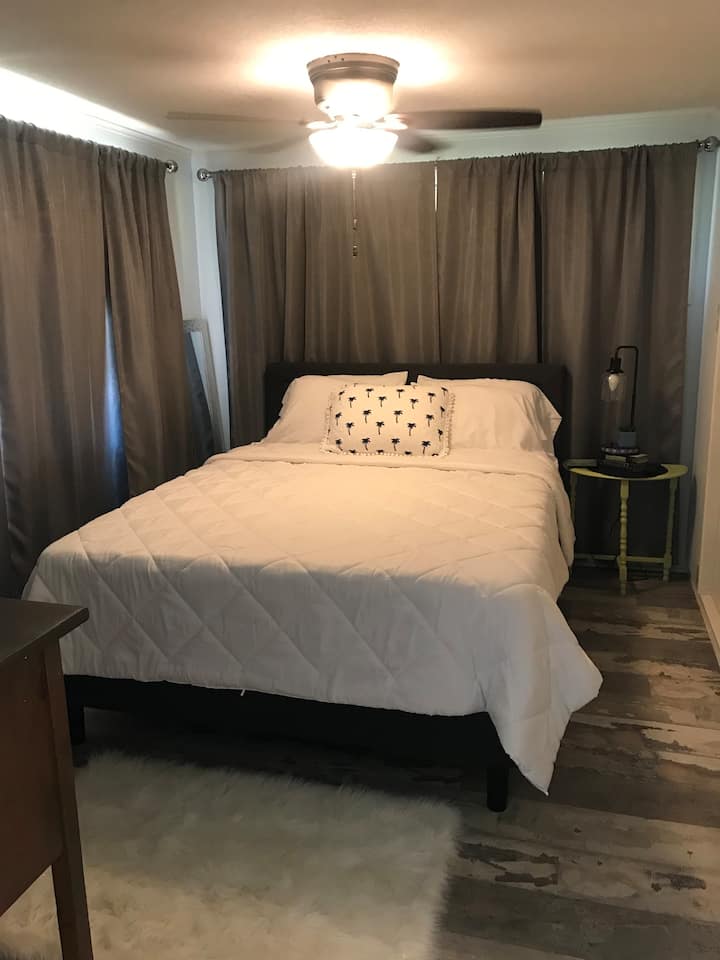 Queen size bed and room also features a flat screen tv. 