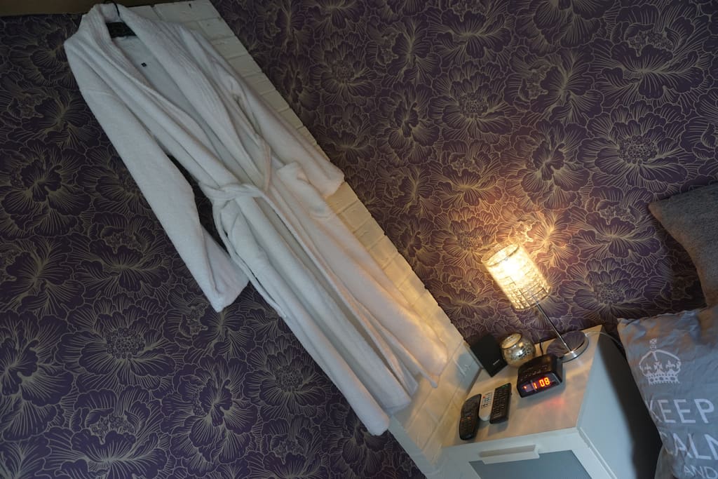 Bedroom 3 - Side lamp, alarm clock, dressing gown, remotes for entertainment systems