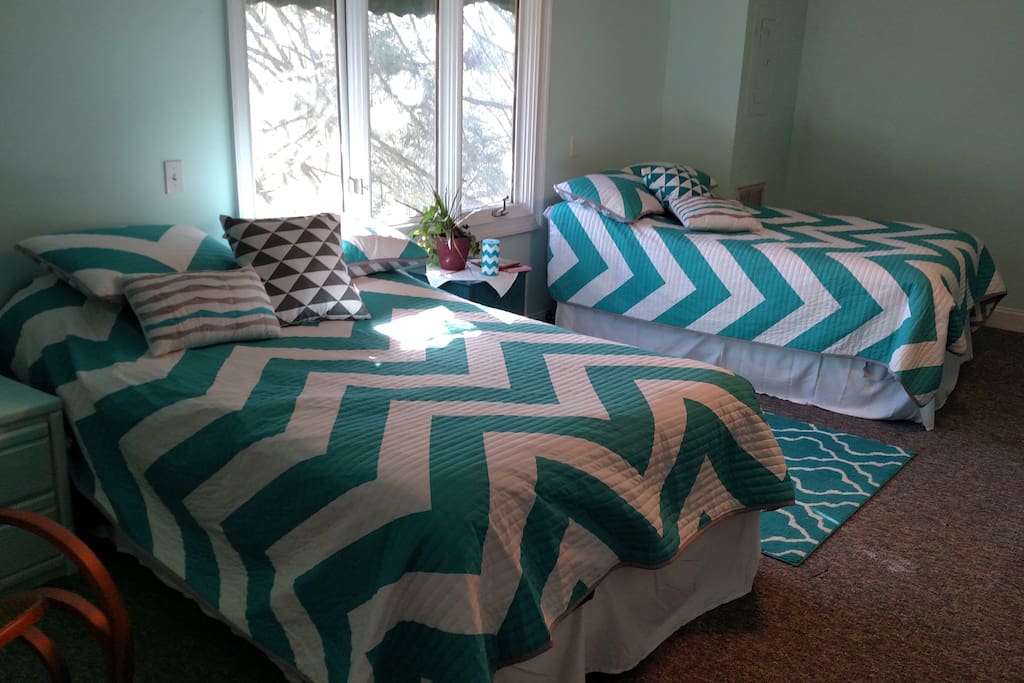 Two double beds, sleeps two or four smaller people, bathroom/shower part of rental. (Shares baths with other two bedrooms.)