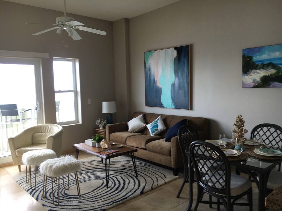 Living room opens to the balcony. 55' UHD Smart TV.