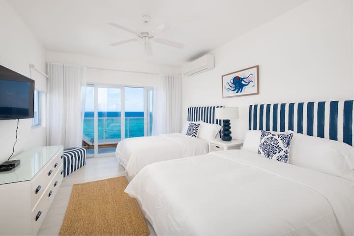Guest bedroom with 2 queensize beds with ensuite overlooking ocean 