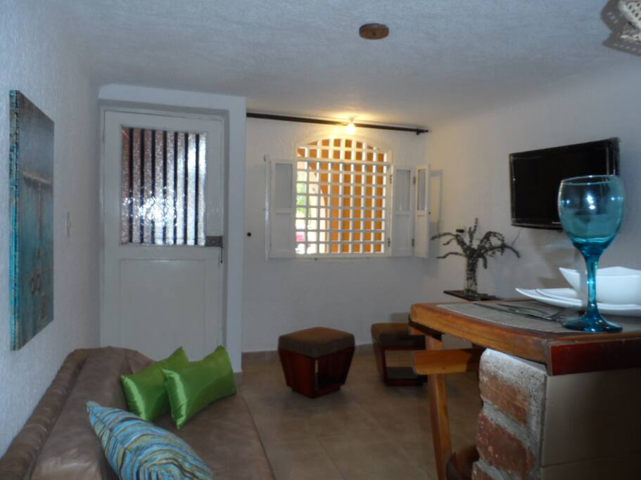Living room with sofa bed and tv with cable