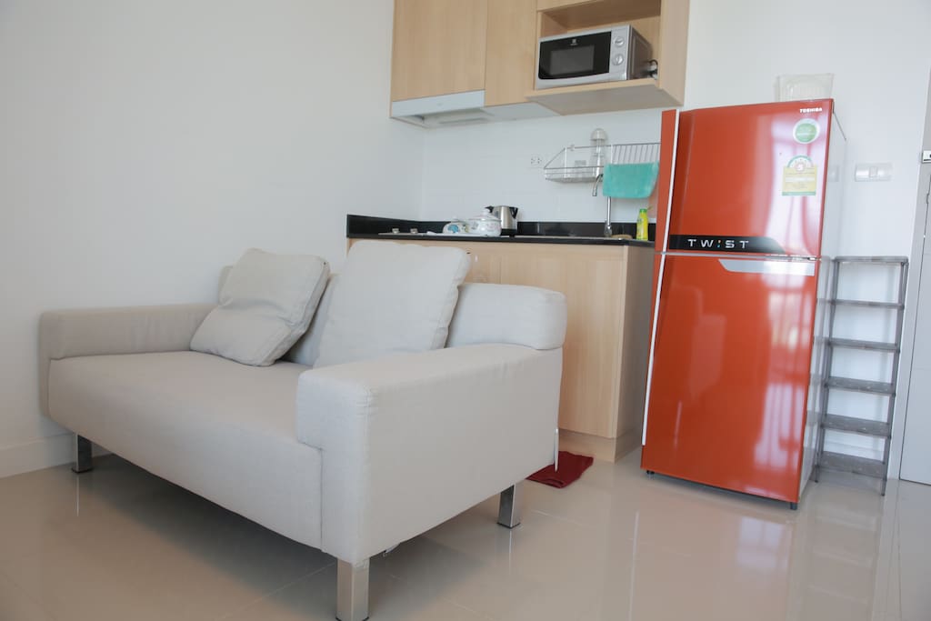 Living room with sofa bed (can be fold to become bed for 2) and kitchen area