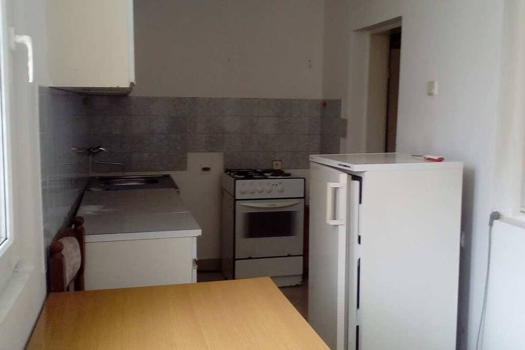 Kitchen area, the door leads to a hall and the bathroom