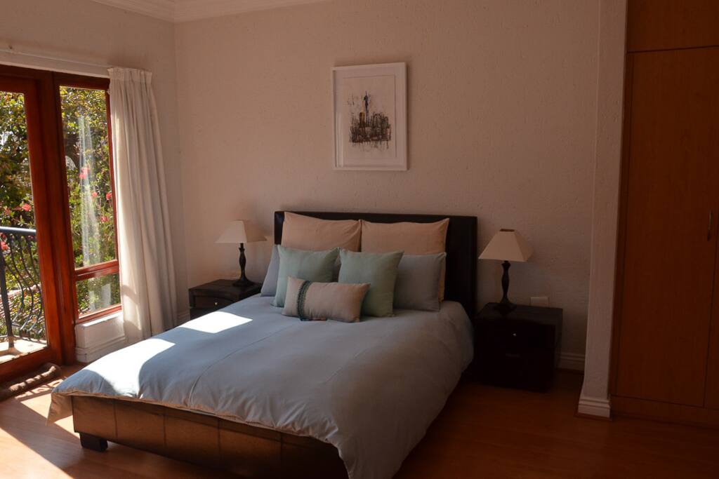 The bedroom has a TV that is connected to DSTV. There is ample cupboard space and hangers to hang clothes and draws to pack away clothing.