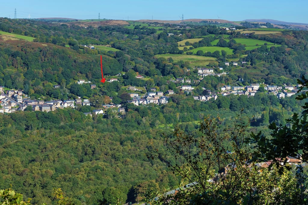 Our village - Ynysmeudwy (means land of the hermit watermeadow). The cottage is located approx by the read arrow. There,s lots of woodland, river, canal walks near. The Brecon Beacons are in the background.