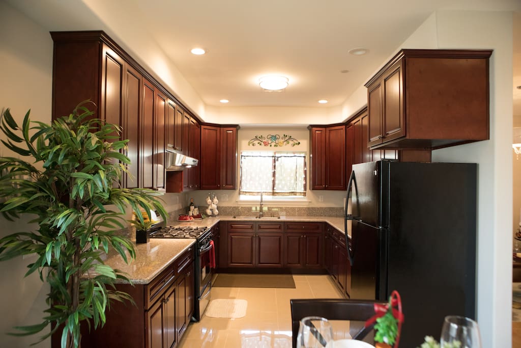 Full kitchen with large counter and open space for cooking.