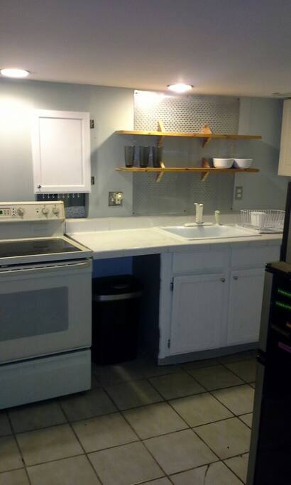 Includes basic kitchenware: glasses, mugs, plates, bowls, silverware, chef's knives, & Tupperware