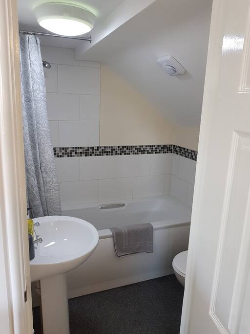 Bathroom with over bath shower