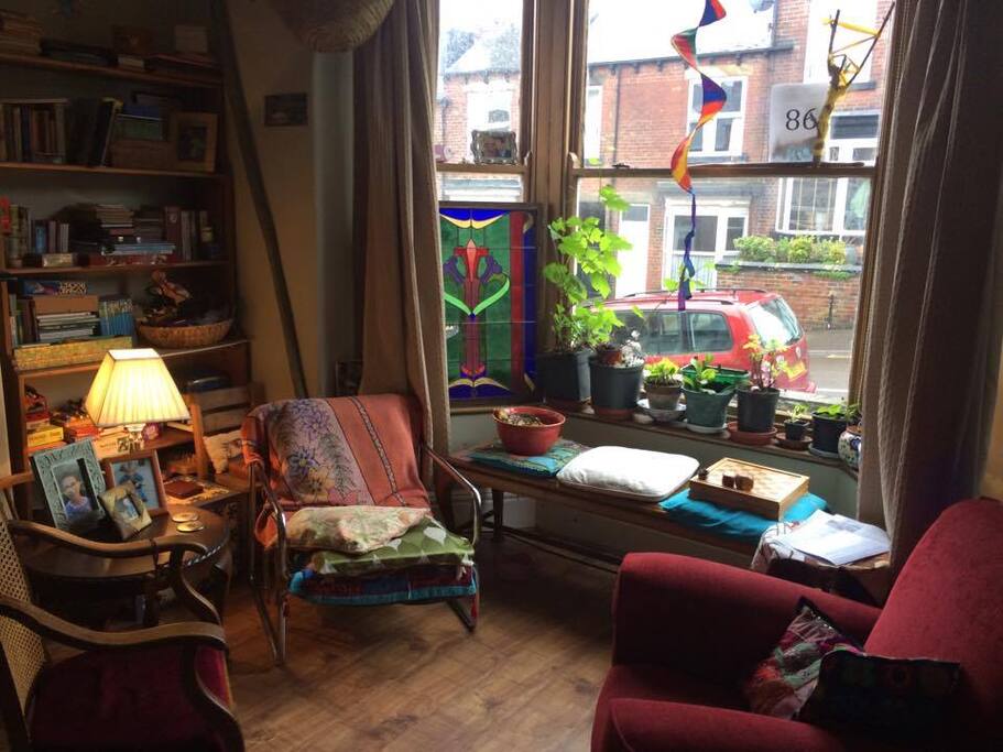 Sunny, street facing sitting room with dining table .