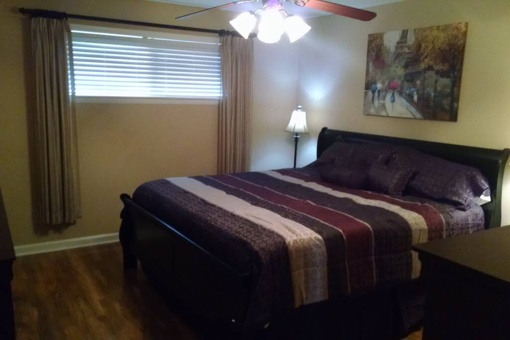 Master bedroom with king bed and plenty of closet and drawer space.