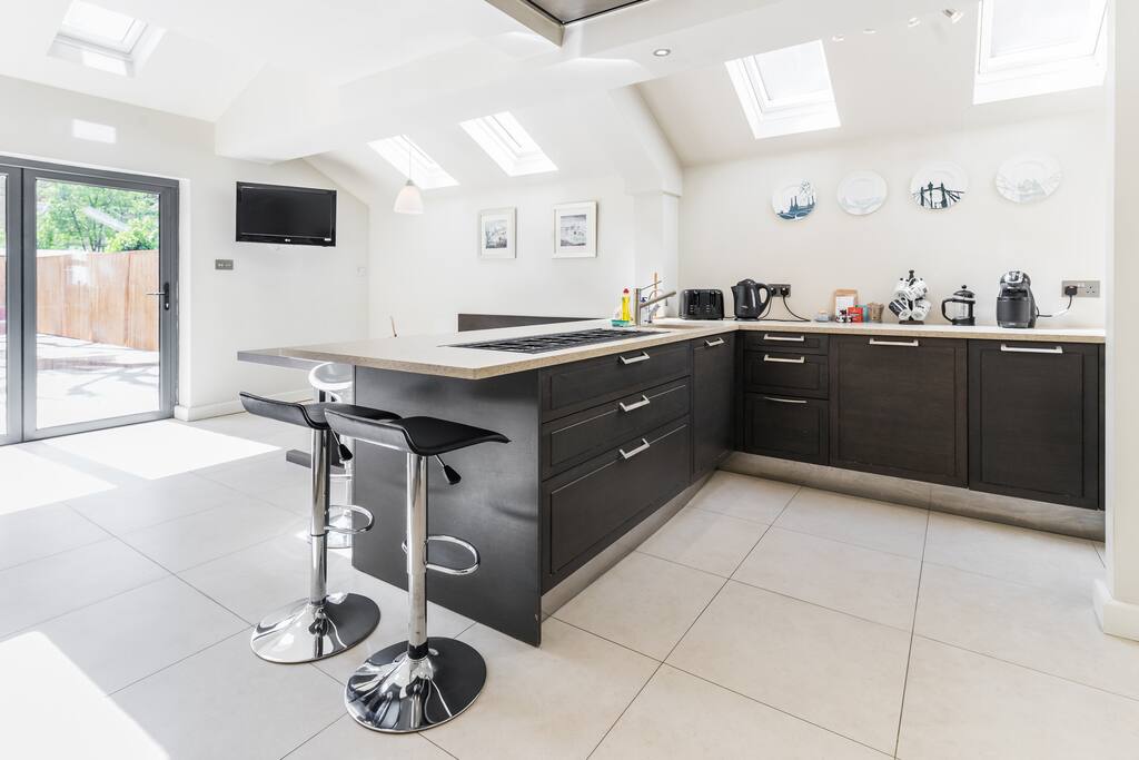 The living room with a bright kitchen area!