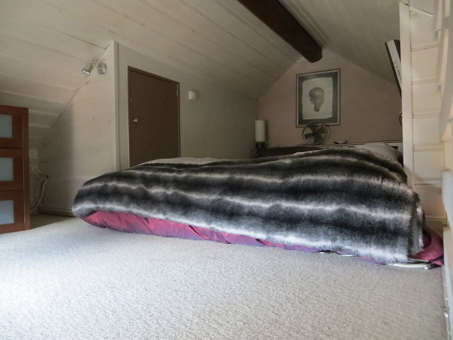 Mezzanine: kingsize bed, chests of drawers; private area above kitchen