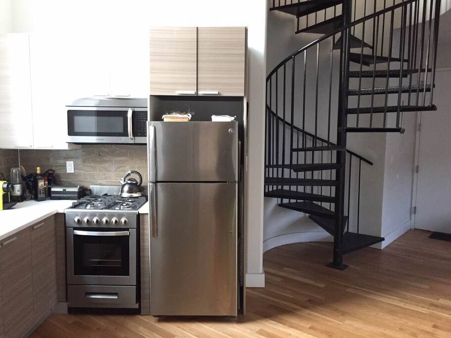 Modern kitchen with serial staircase to upstairs bedrooms