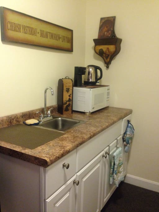 A kitchenette with all the necessities for cooking... two top electric burner and small infrared oven. One-cup coffee maker and an electric tea kettle is available too.