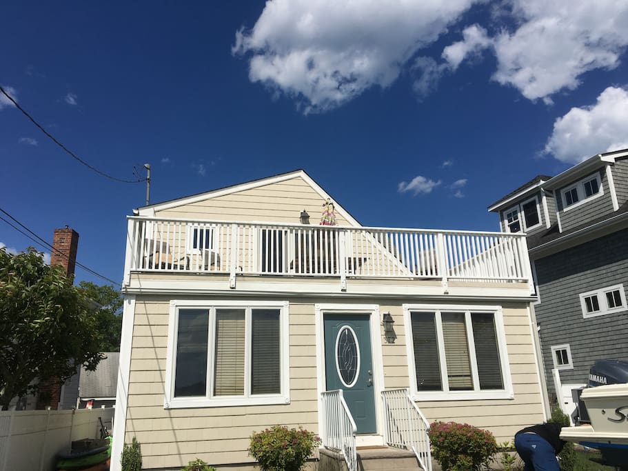 Front of home overlooking the waterfront with deck.
