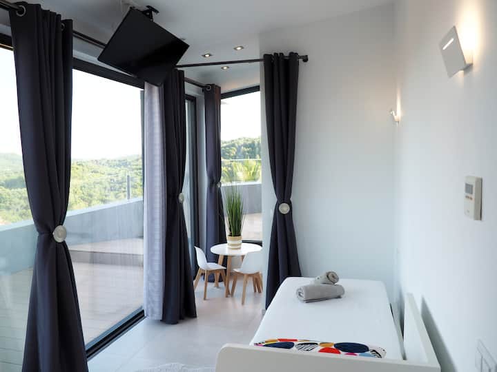 Fourth suite with  two seater sofa bed, smart TV,  and own bathroom. The suite has direct access to the terrace.