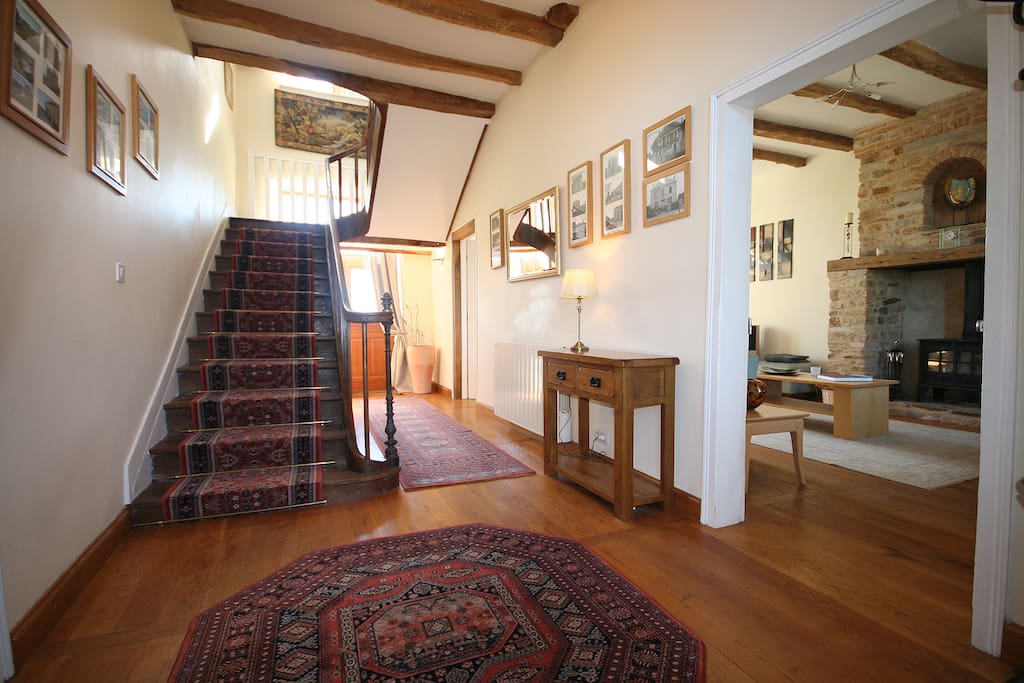 Hall with antique staircase and view into lounge