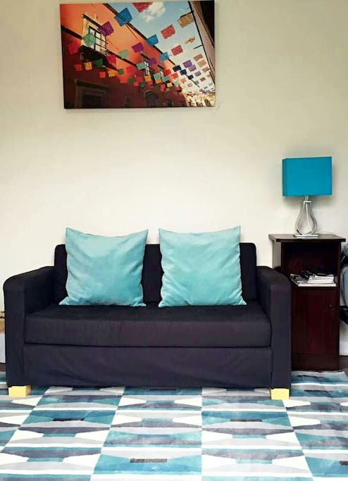 comfortable couch and painting in the room