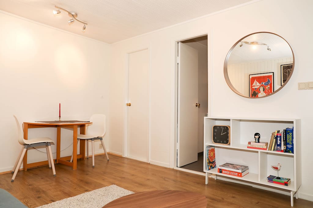 Main living area, dining table, doors to bathroom an kitchen
