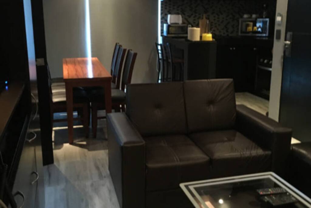 Spacious living room area with flat TV screen. WiFi and cable system included.