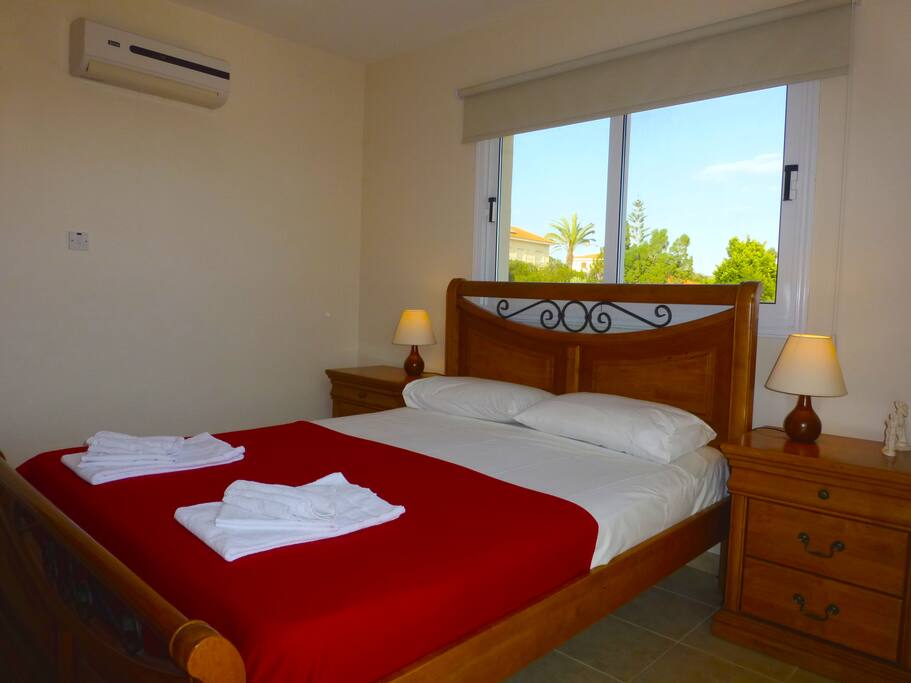 Double bedroom with A/C with patio doors leading to balcony.