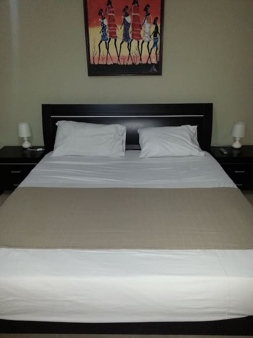 en suite double bedroom with a kingsize bed