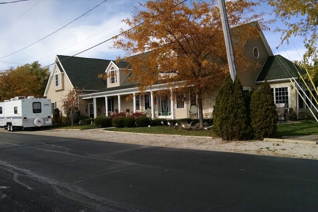 Front of home with 55ft covered porch with BBQ grills