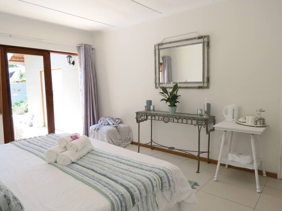 This bedroom has a tea and coffee station, fan and hair dryer