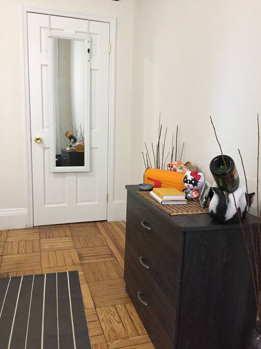 Your bedroom with double windows and great light, closet and full length mirror, dresser and reading nook with chair and table.