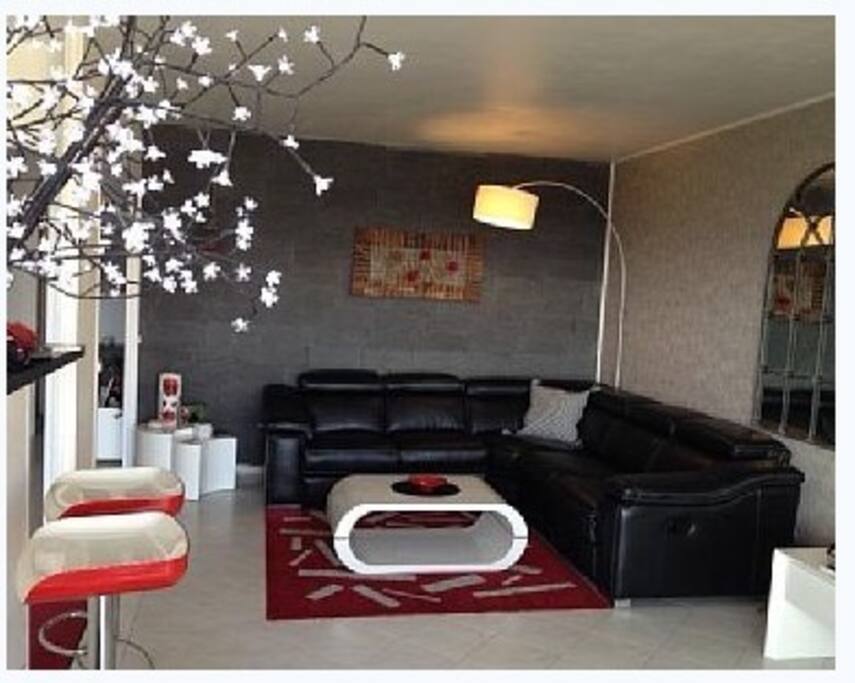 Large open living room...new leather sofa with two built in recliner ends Big Flat Screen Bose System and Eng. TV
