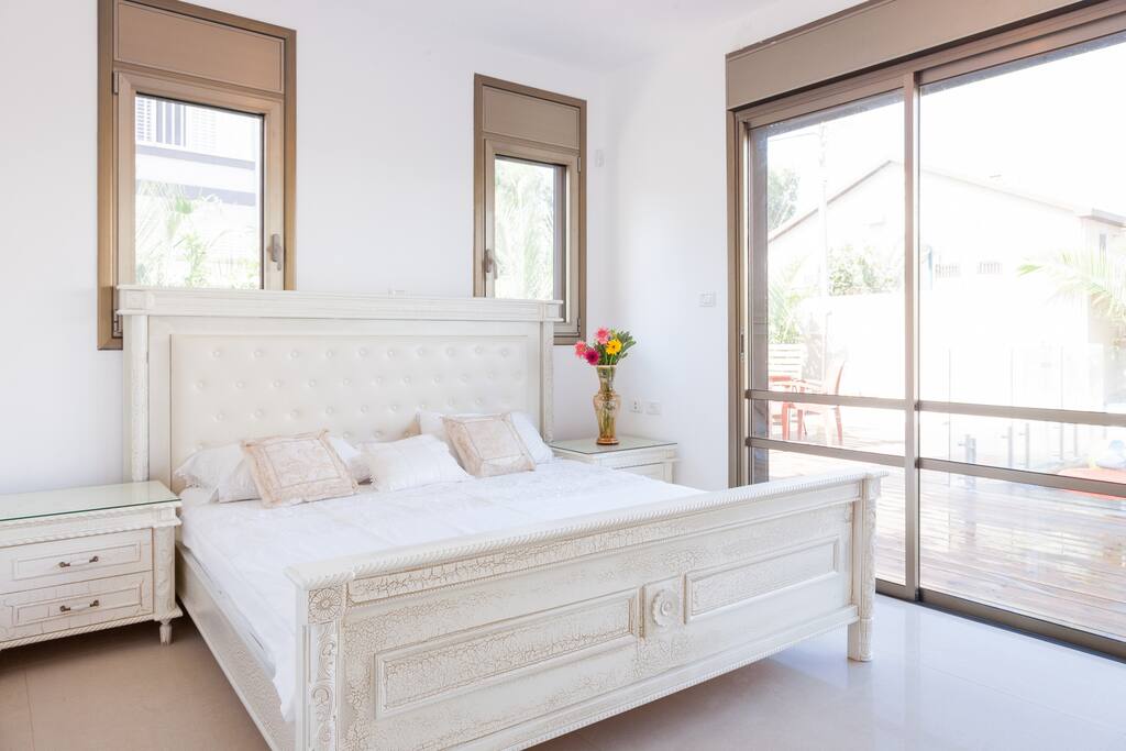 Master Bedroom. Everything is made out of luxurious wood. With an exit to the pool