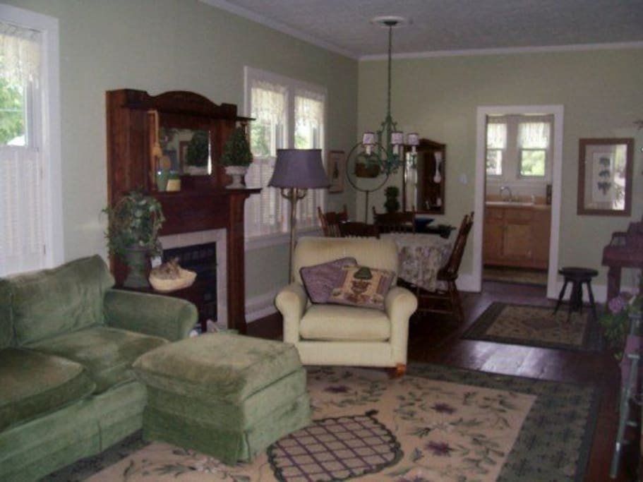 A spacious living space with ample seating, flat screen TV, WiFi, fireplace, piano and more.