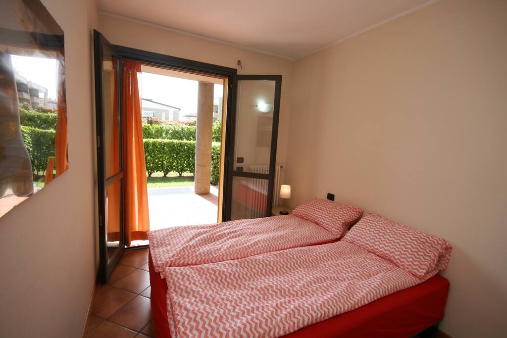 Bedroom with double doors to balcony and garden