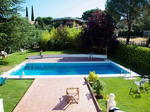 A villa residence with a large garden and swimming pool