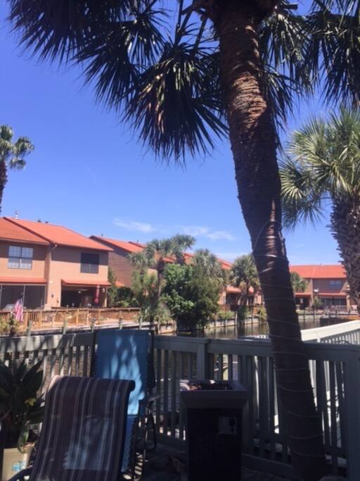 The deck is so peaceful and has great shade trees. There is a table, chairs, and nice grill.