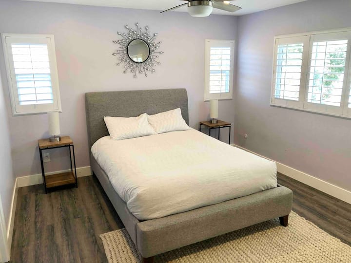 Master Bedroom #2 with a queen bed overlooks the pool and backyard.
